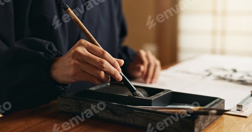 Preview: Hands, brush in ink for writing and Japanese calligraphy or ancient script for art and inkstone. As