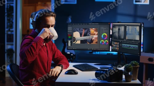 Preview: Videographer color correcting clips while listening music in headphones
