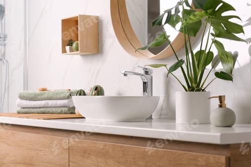 Preview: Stylish vessel sink on light countertop in modern bathroom
