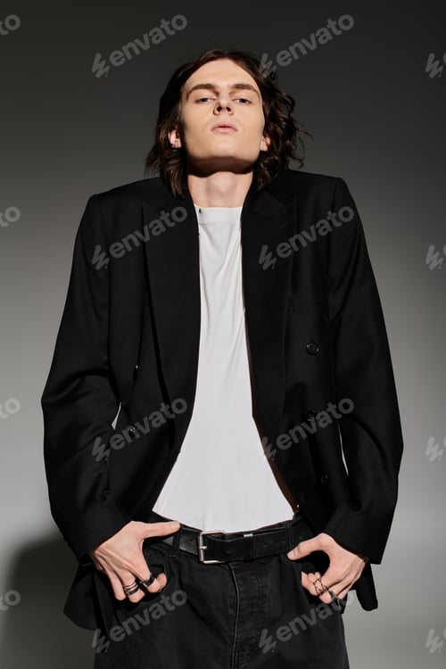 Preview: A stylish young man exudes confidence in a chic black blazer and minimalist outfit.