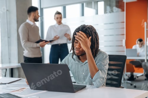 Preview: Exhausted, feeling tired, headache. People are working in the office together