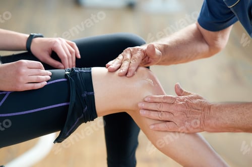 Preview: Close up woman suffering from pain in knee at gym.