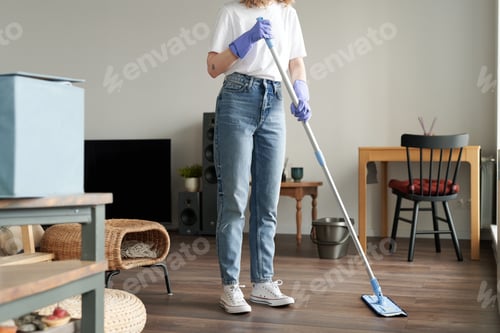 Preview: Woman wiping the floor with mop