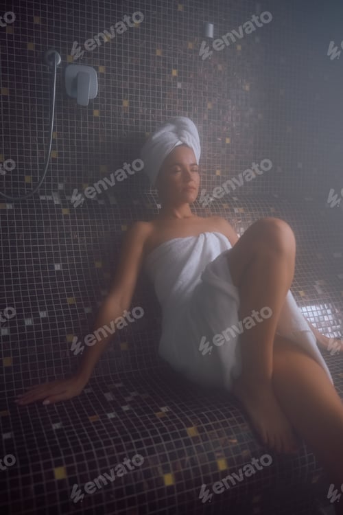 Preview: Young woman relaxing in steam room at the spa.