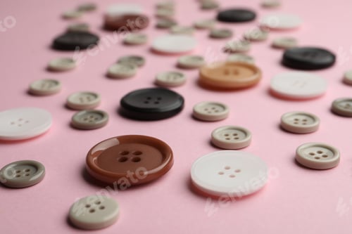 Preview: Many sewing buttons on pink background, closeup view
