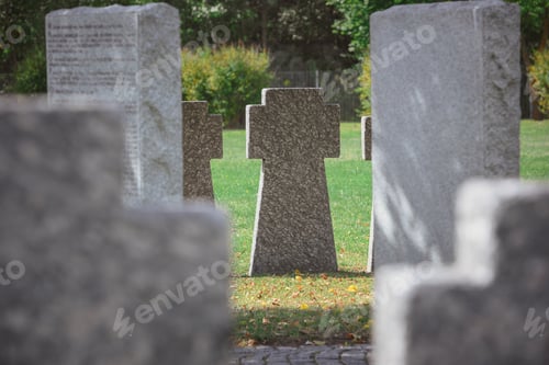 Preview: selective focus of memorial stone crosses placed in row at cemetery