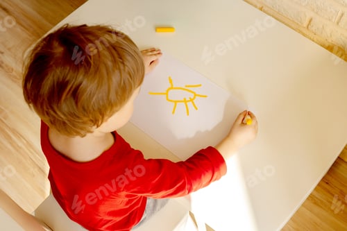 Preview: boy draws with felt pen in the album