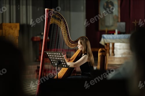 Preview: Young Female Musician Giving Concert in Church Playing Music on Harp