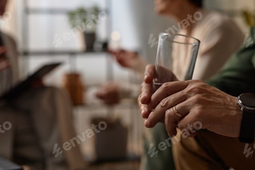 Preview: Man holding glass of water in couples therapy
