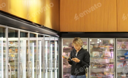Preview: Man Choosing Frozen Food From A Supermarket Freezer