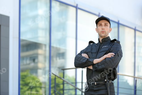 Preview: Portrait of male security guard in uniform outdoors