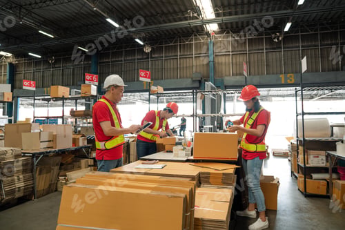 Preview: Warehouse worker team working in a large warehouse.