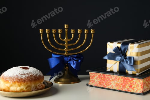 Preview: Hanukkiah, donut, gift box and book on black background
