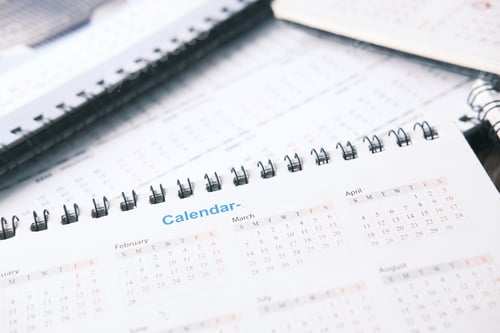 Preview: deadline concept with stack of calendar and pencil on color background