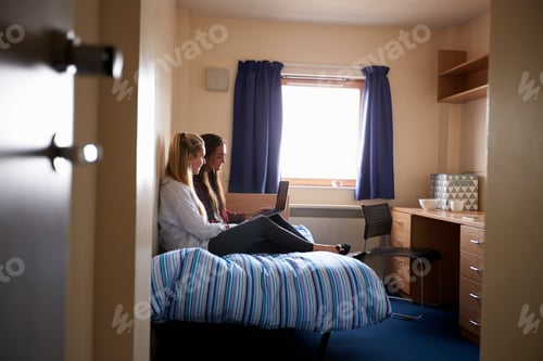 Preview: Female Students Working In Bedroom Of Campus Accommodation