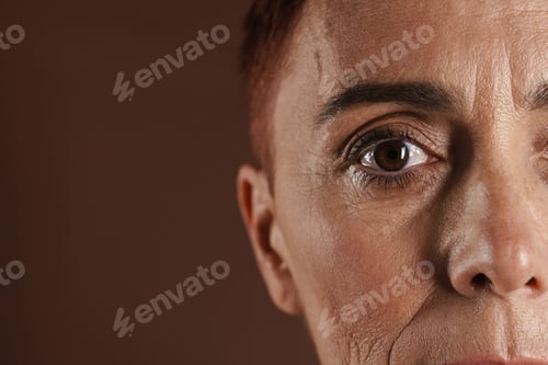 Preview: Senior ginger woman with short hair posing and looking at camera