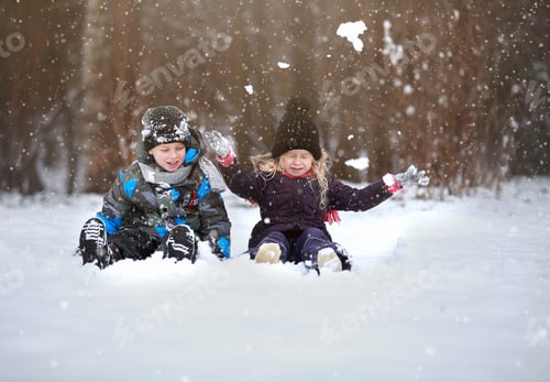 Preview: Two children playing on snow in winter time