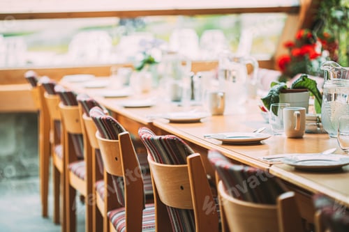 Preview: Cozy Interior Of Summer Cafe. Jug Of Water On Table And Cutlery Laid Out