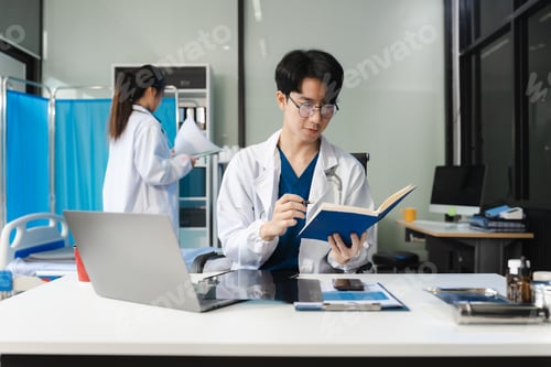 Preview: Medical Technology Concepts. male doctor reviews patient records on smartphone and desktop PC.
