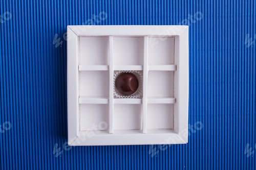 Preview: Top view one single chocolate candy in the box.