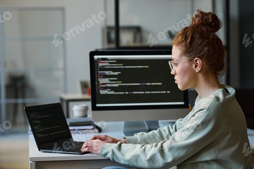 Preview: Young woman typing programming codes