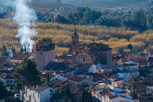 Preview: smoke billows from the chimney of a building surrounded by lots of trees