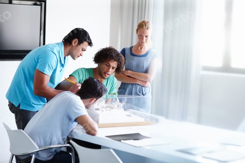 Preview: Skeptical about the structure. A group of architects discussing a building model during a meeting.