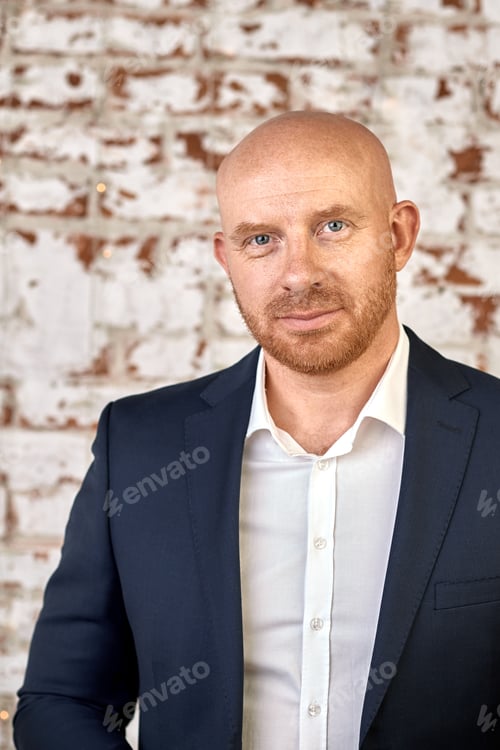 Preview: Bald man in a suit and tie on a white background