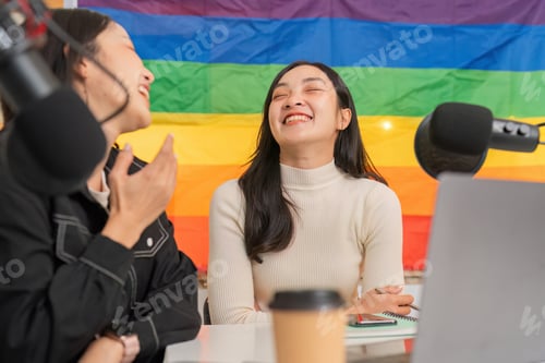 Preview: LGBTQIA women enjoying a light-hearted moment in a podcast studio