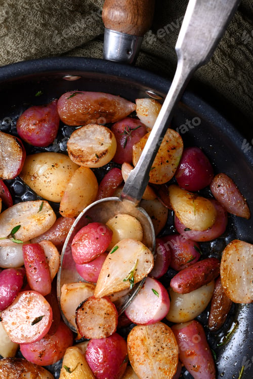 Preview: Seasoned roasted radishes in frying pan with spoon