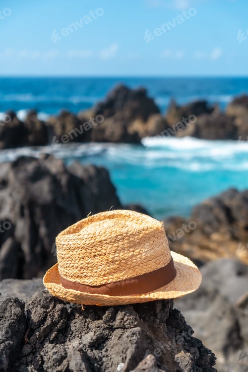 Preview: Hat next a natural pool in summer, coastal town of Porto Moniz, Madeira. Vertical photo, lifestyle