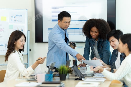 Preview: Business people showing team work while working in board room in office interior.