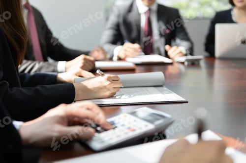 Preview: A Japanese businessperson having a meeting in a brightly lit conference room.