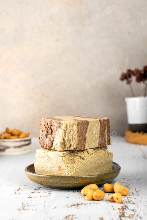 Preview: Minimalistic. Tasty eastern sweet dessert halva from sunflower seeds, cocoa and tahini on beige wood