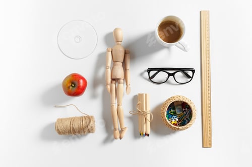 Preview: Stationary items and tools arranged on a desk with a model figure and a cup of coffee