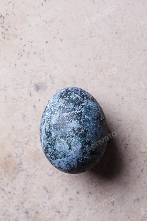 Preview: Single Easter egg painted in trendy denim blue, brown background.