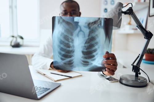 Preview: Afro-American medic with an x-ray opposite to his face