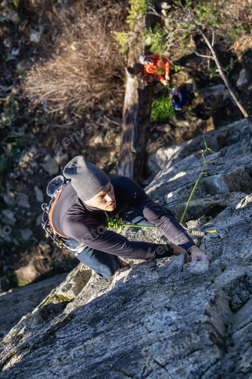 Preview: Male Rock climber climbing on the edge of the cliff