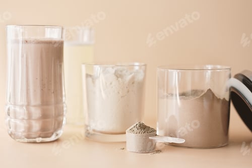 Preview: whey protein drink in a glass and jars with protein powder on beige background