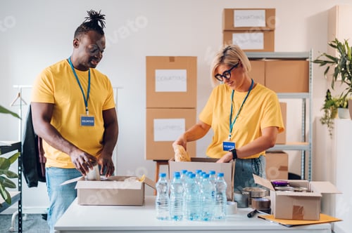 Preview: Group of multiracial volunteers working in community charity donation center