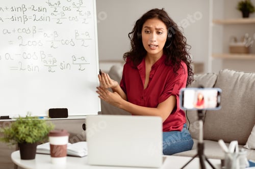 Preview: Lady teacher giving online lesson to students recording video