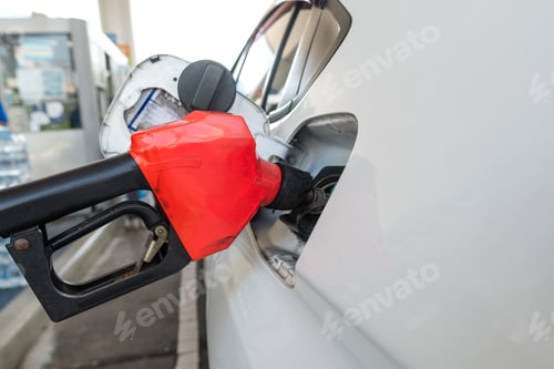 Preview: Close Up pumping gasoline fuel nozzle in tank for car at gas station.