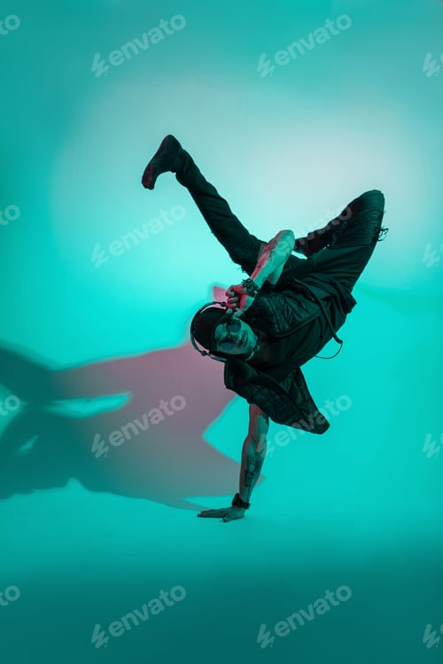 Preview: Handsome stylish dancer cool man in fashionable clothes dancing in colorful studio