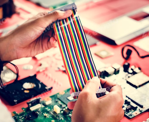 Preview: Clsoeup of hands holding computer breadboard flat wires cables
