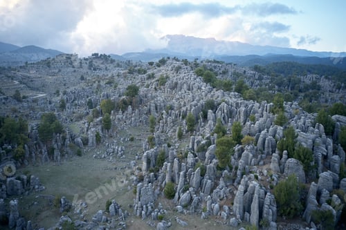Preview: Aerial panoramic view of valley with majestic rocky formations.