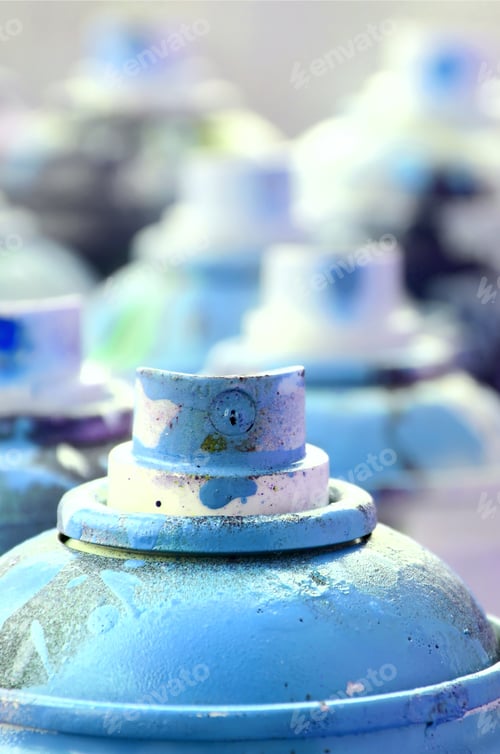 Preview: A lot of dirty and used aerosol cans of bright blue paint