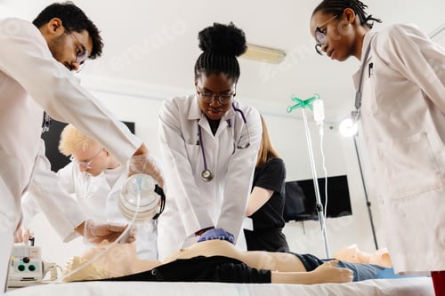 Preview: Doctors practicing cardiopulmonary resuscitation and intravenous injection on medical manikin