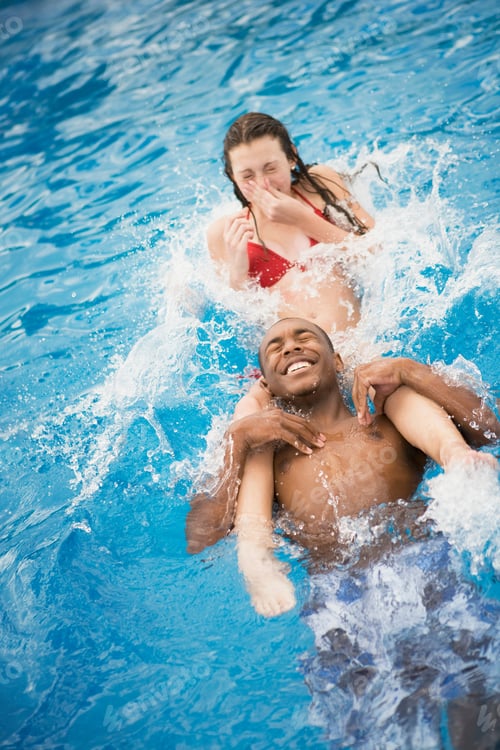 Preview: teen boy and girl playing in pool