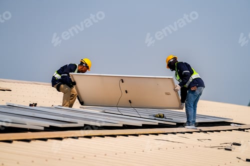 Preview: Solar panels installation. Construction workers with safety hardhat working on roof