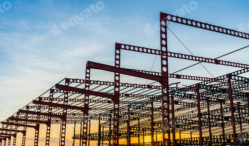 Preview: Steel beam construction of industrial building structure on sunset in the evening